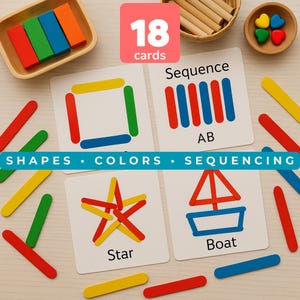 May include: Educational game set with 18 cards featuring shapes, colors, and sequencing. The cards display colorful stick figures forming shapes like a square, star, and boat. Wooden sticks and small wooden bowls with colorful heart-shaped pieces are also present.