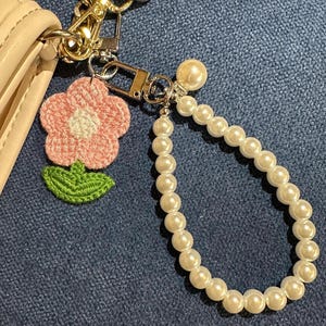 Pink flower keychain with pearl accessory