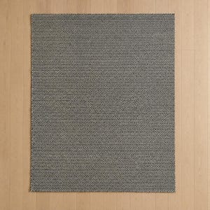 May include: A rectangular area rug featuring a dense, repeating black and white herringbone pattern. The woven textile displays a consistent zigzag texture across its entire surface, creating a high-contrast visual effect with sharp, clean lines.
