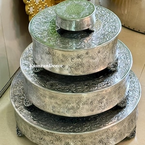 May include: A set of three ceramic mugs with a speckled, matte finish in cream, light grey, and dark grey. Each mug has a simple, minimalist design, ideal for tea or coffee.