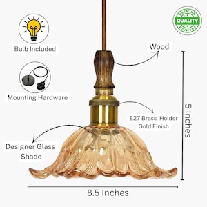 May include: A pendant light featuring a fluted amber glass shade, a brass E27 holder, and a dark wood neck. The fixture measures 5 inches in height and 8.5 inches in width. It includes a bulb, mounting hardware, and a premium quality label.