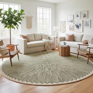 May include: A large, round area rug featuring a dark green, sunburst-inspired radial pattern on a light cream background. The design consists of thin, radiating lines that extend from the center toward the outer edge, creating a textured effect.