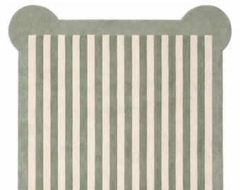 May include: A rectangular rug featuring a vertical striped pattern in sage green and cream. The rug has a solid sage green border and rounded, protruding corners at each of the four edges, creating a distinct shape with a soft, textured surface.