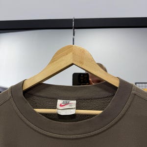 May include: A set of three ceramic mugs with a speckled, matte finish. The mugs are in shades of cream, light gray, and dark gray. Each mug has a simple, minimalist design, perfect for coffee or tea.