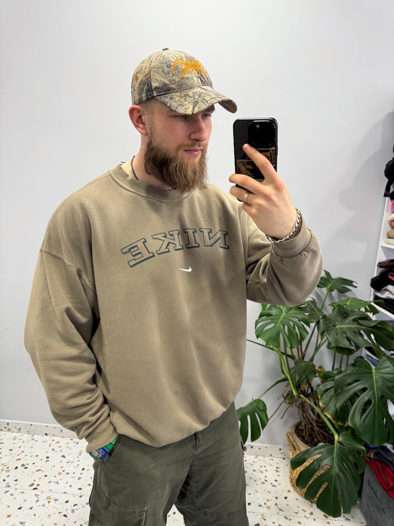 May include: A handmade wooden sign with the text "Welcome" in a handwritten style. The sign is painted white with a distressed finish, and a small green leaf is attached to the top. The sign measures approximately 12 inches wide.