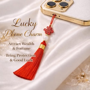 May include: A white ceramic mug with a black handle and the text "But First, Coffee" in a bold, black font. The mug is set against a blurred background, suggesting a cozy setting.