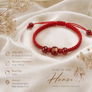 May include: Red adjustable bracelet with natural red agate beads and a gold horse design. The bracelet is made of high-quality cord and is adjustable from 6.3 to 10.2 inches. The bead size is 8 mm. The text says "Year of the Horse".