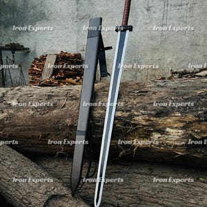 May include: A large sword with a black blade and white accents, resting on a wooden log. The handle is wrapped in brown material. A black sheath is positioned next to the sword. The words "Iron Experts" are watermarked across the image.