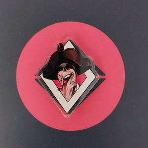 May include: A black and white illustration of a grinning skull wearing a tricorn hat, framed in a white diamond shape against a red background.