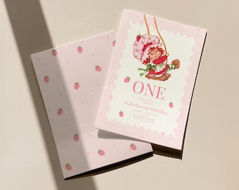 May include: Pink birthday invitation with a strawberry theme. The invitation features a cartoon character on a swing, the word "ONE", and the text "Isabella's 1st Birthday". The back of the invitation has a pink strawberry pattern.