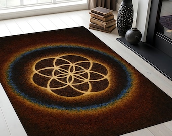May include: A rectangular brown area rug with a central design of interlocking circles in shades of gold and tan. A blue ring surrounds the central design. The rug is placed on a light-colored wooden floor.