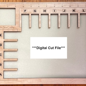 May include: A wooden craft organizer with a ruler along the top edge and labeled slots. The organizer has the text "It's Sew Crafty" and "***Digital Cut File***". The design includes lettered and numbered sections for organizing materials.
