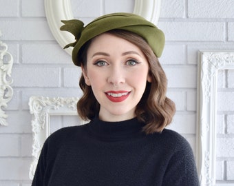 Vintage Muted Green Wool Hat with Side Ribbon and Emblem Adornment by Marguerite
