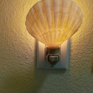 May include: A set of three ceramic mugs with a speckled, matte finish. The mugs are in shades of cream, light gray, and dark gray. Each mug has a simple, minimalist design, perfect for coffee or tea.