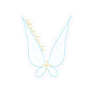 May include: A sticker featuring a pair of light blue fairy wings with delicate line art and a gold starburst at the center. The words "Faith trust and pixie dust" are written in gold script.