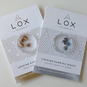 May include: Two packs of earring backs. One pack contains gold-tone locking earring backs, the other silver-tone. The packaging features the text "LOX Classic" and "Never Lose Another Earring".