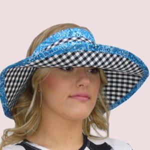 May include: A wide-brimmed sun hat with a black and white checkered pattern on the brim and a blue bandana pattern on the crown.
