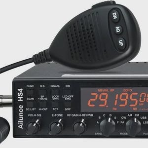 May include: A black Ailunce HS4 amateur radio transceiver with a connected handheld microphone. The front panel features a digital display showing 29.195.00, multiple control knobs, function buttons, and a green LED indicator light labeled TX/RX.