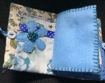 Blue fabric and felt needlecase with heart centre and pockets