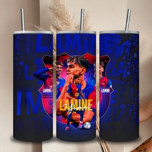 May include: A set of three stainless steel insulated tumblers with a blue and red design featuring a soccer player. The tumblers have a silver straw and a blue and red background with the name "Lamine Jamal" in gold lettering.