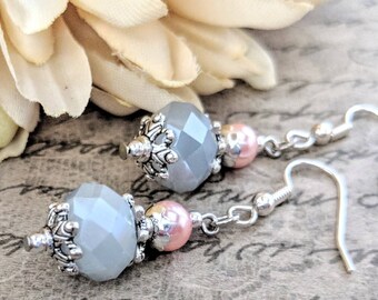 Puede incluir: Pendientes colgantes con cuentas grises facetadas, perlas rosas y detalles plateados. Los pendientes tienen un diseño clásico con cierre de gancho, adecuados para el uso diario o ocasiones especiales.