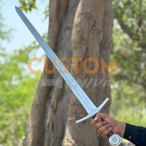 Custom Engraved Sword featuring intricate Norse runes on a high-carbon steel blade. This Viking Sword includes a detailed hilt and matching scabbard. A premium Medieval Sword designed for display, combining the reach of a Longsword with personalized historical artistry.