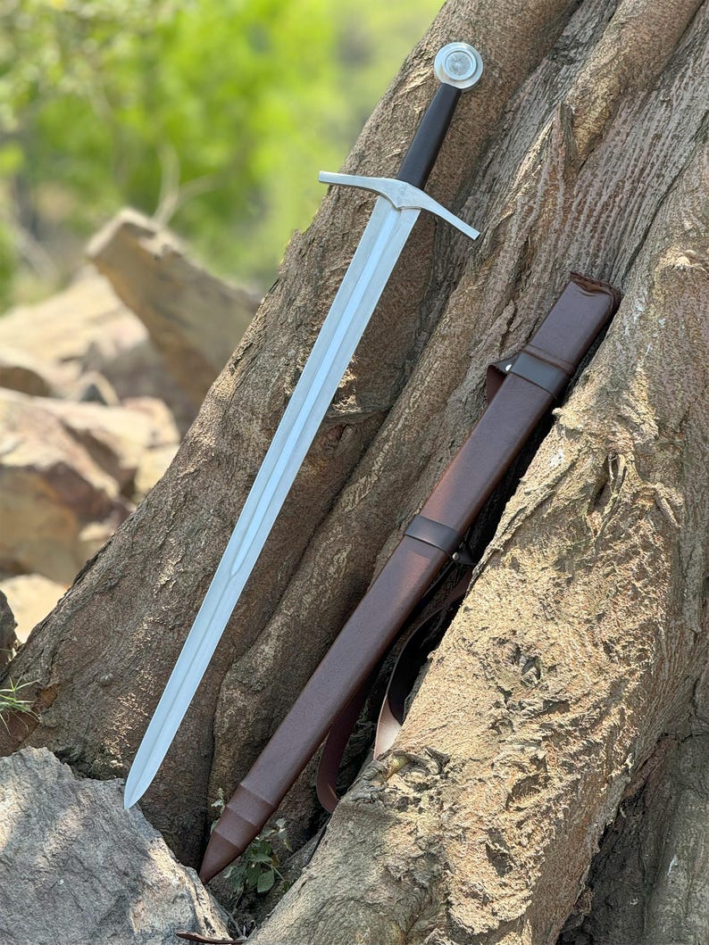 Custom Engraved Sword featuring intricate Norse runes on a high-carbon steel blade. This Viking Sword includes a detailed hilt and matching scabbard. A premium Medieval Sword designed for display, combining the reach of a Longsword with personalized historical artistry.