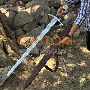Custom Engraved Sword featuring intricate Norse runes on a high-carbon steel blade. This Viking Sword includes a detailed hilt and matching scabbard. A premium Medieval Sword designed for display, combining the reach of a Longsword with personalized historical artistry.