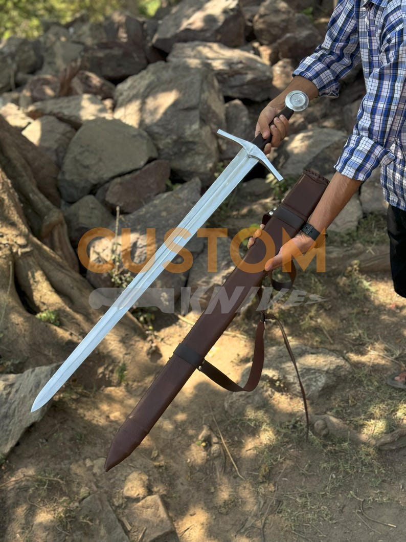 Custom Engraved Sword featuring intricate Norse runes on a high-carbon steel blade. This Viking Sword includes a detailed hilt and matching scabbard. A premium Medieval Sword designed for display, combining the reach of a Longsword with personalized historical artistry.