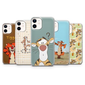 May include: A selection of phone cases showcasing Tigger from Winnie the Pooh. The cases feature different designs, such as Tigger's face, full-body poses, and patterns. The colour palette includes orange, brown, and blue.