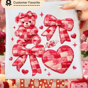 May include: A white fabric with a red and white checkered teddy bear, bows, hearts, and a candy graphic. The words "Customer Favorite" are in a black and white banner in the upper left corner. The word "LOVE" is in red letters at the bottom.