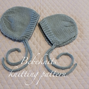 May include: Two light blue baby bonnets with ties. The bonnets are knitted and have a simple design. The text "Bebeknits knitting pattern" is visible in the image.