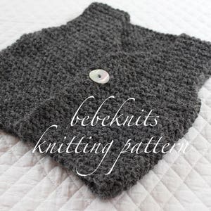 May include: A grey knitted waistcoat with a button fastening. The waistcoat is made with a textured stitch and has the text "bebeknits knitting pattern" on it.