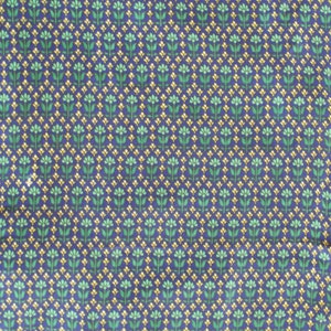 May include: A blue fabric with a repeating pattern of small green and yellow flowers.