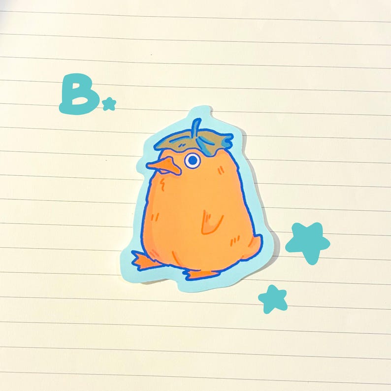 May include: An orange sticker of a cartoon duck-like creature with a leaf hat and blue outline. The sticker has a light blue background with the letter "B" and two blue star shapes.