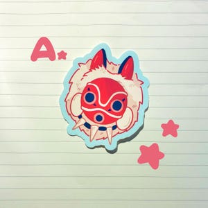 May include: A sticker featuring a red and white mask with a furry, off-white border, set against a light blue outline. The sticker has a cartoonish style, with pink stars and the letter "A" in the upper left corner.