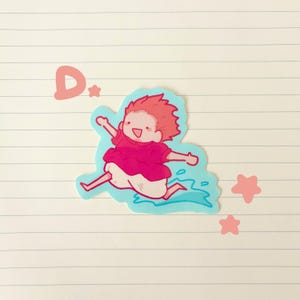 May include: A sticker featuring a cartoon character with spiky red hair and a pink outfit, mid-stride in a blue water-like shape. The letter "D" and three pink stars are also present.