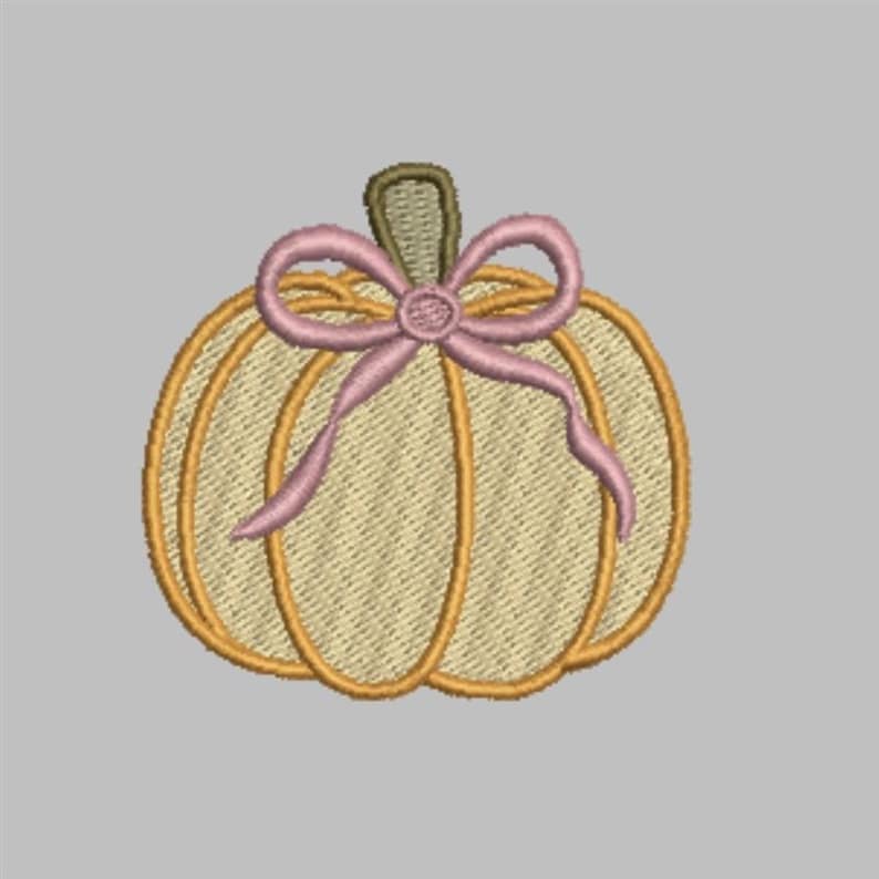 Puede incluir: Dise&ntilde;o de calabaza bordada con cuerpo beige claro, contorneado en naranja y tallo verde. Un lazo rosa adorna la parte superior. Adecuado para manualidades y decoraciones con tem&aacute;tica oto&ntilde;al.