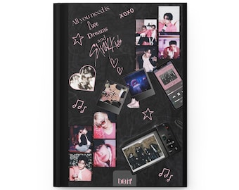 May include: Black journal with a collage of photos, musical notes, and text. The text includes "All you need is Love Dreams and Stray Kids" and "XOXO". Photos include images of a musical group.