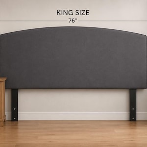 May include: A dark gray upholstered headboard with a curved top edge. The text KING SIZE and 76 inches is displayed above the headboard, indicating its width. The headboard is supported by two black vertical legs attached to the base.