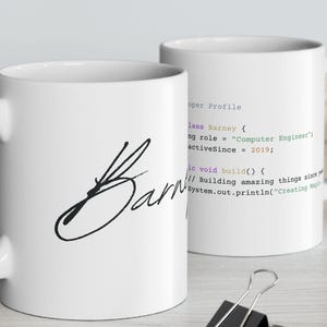 May include: A set of three ceramic mugs with a speckled, matte finish. Each mug features a different color: light blue, cream, and gray. The mugs have a simple, modern design with a rounded shape and a comfortable handle.