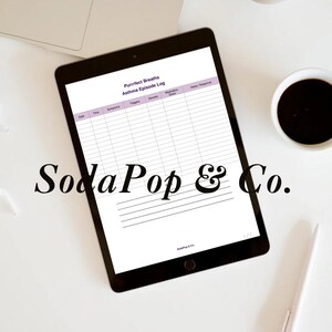 May include: A digital tablet displaying a "Purrrfect Breaths Asthma Episode Log" on a white background. The tablet is black, with the text "SodaPop & Co." in a cursive font. A laptop, coffee cup, and pen are also visible.