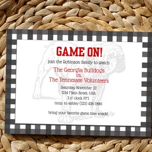 May include: Invitation with a black and white checked border and the text "GAME ON!" in red. It announces a gathering to watch The Georgia Bulldogs vs. The Tennessee Volunteers on November 22nd at 2 PM. Includes contact information.
