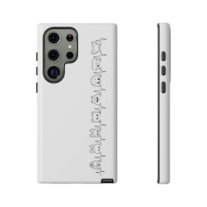 May include: White phone case featuring a black and white illustration of cartoon animal faces along a heartbeat line. The case has a camera cutout and side buttons.