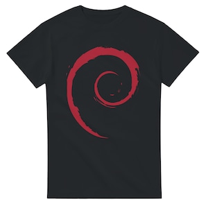 May include: Black t-shirt featuring a large red spiral design on the front. The graphic is a stylized, brushstroke-style swirl. The shirt is a basic crew neck style.