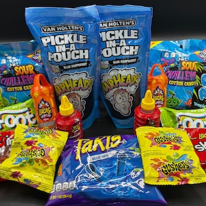 May include: Assortment of colorful candy and snacks, including bags of blue raspberry "Pickle-In-A-Pouch", "Warheads" and "Takis" chips. Also, "Pop Rocks" popping candy, "Gushers", and "Lucas" candy with a red sauce bottle.