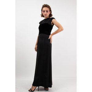 May include: A black maxi dress with a velvet bodice and a simple, sleeveless design.