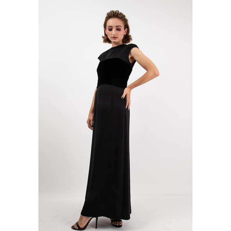 May include: A black maxi dress with a velvet bodice and a simple, sleeveless design.