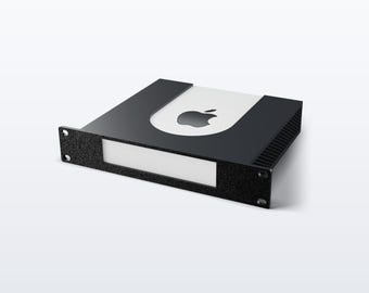 May include: A black metal rack mount enclosure featuring a textured front panel with a rectangular cutout. The top surface is black with a white U-shaped insert displaying a black Apple logo. The side panels have vertical ventilation slats.