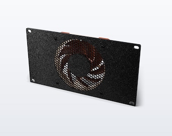 May include: A rectangular black mounting plate with a textured finish featuring a central circular opening covered by a black metal mesh grille. A dark fan with curved blades is visible behind the grille, and small red components are visible at the top.